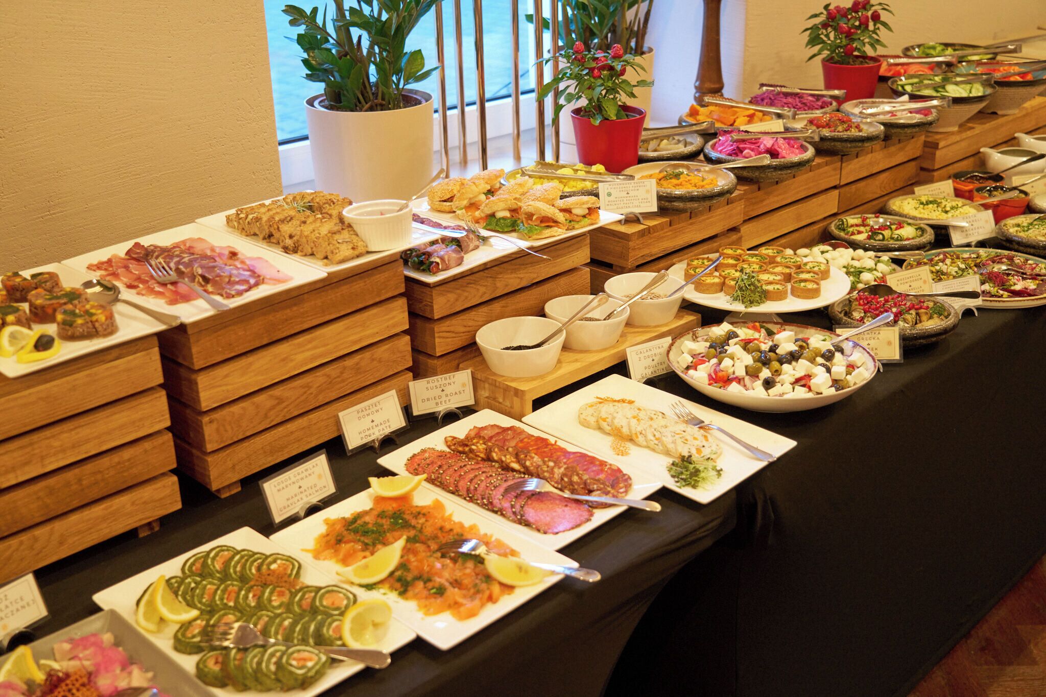 A buffet with various food items and labels.