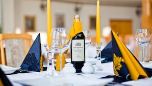A table set with a bottle of wine, candles, and glassware. - Panorama Hotel - Downtown (Szczecin)