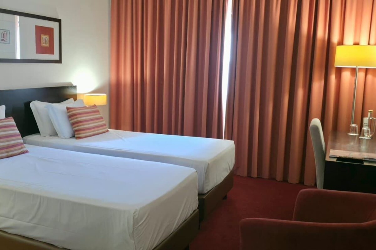 Twin Room | Minibar, in-room safe, desk, soundproofing