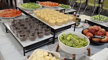 A buffet setup with various food items and beverages.
