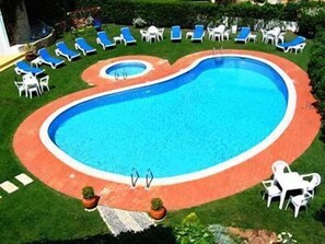 Piscine extérieure en saison, chaises longues