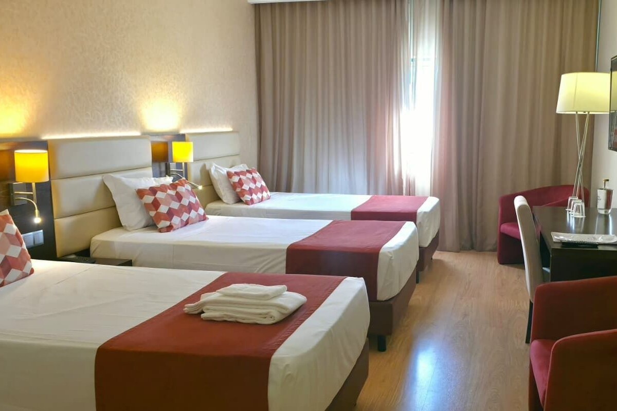 Triple Room | Minibar, in-room safe, desk, soundproofing