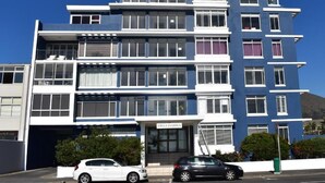 A multi-story building with a blue facade, multiple balconies, and a visible entrance labeled "Villa Marina." - 24 Villa Marina (Cape Town)