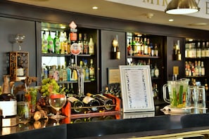 A bar area with a wine rack, a menu board, and various bottles and glasses. - The Commodore Hotel (Cape Town)