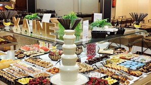 A buffet with various food items and a HEDE® dispenser.
