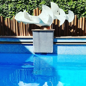 Outdoor pool, open 8 AM to 8 PM, pool loungers