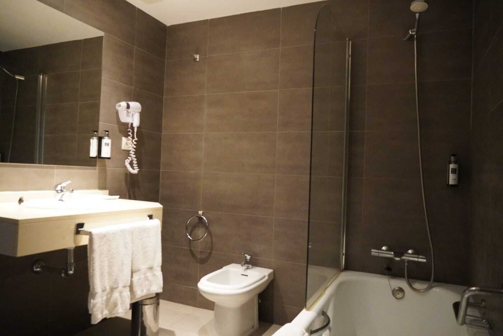 Un baño moderno con ducha, bidé y bañera.