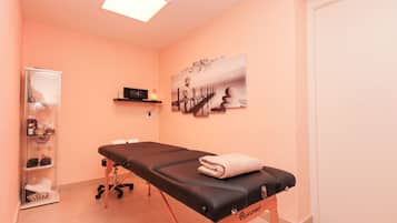 Guest rooms feature a clinical examination table with medical supplies and a framed artwork on the wall.