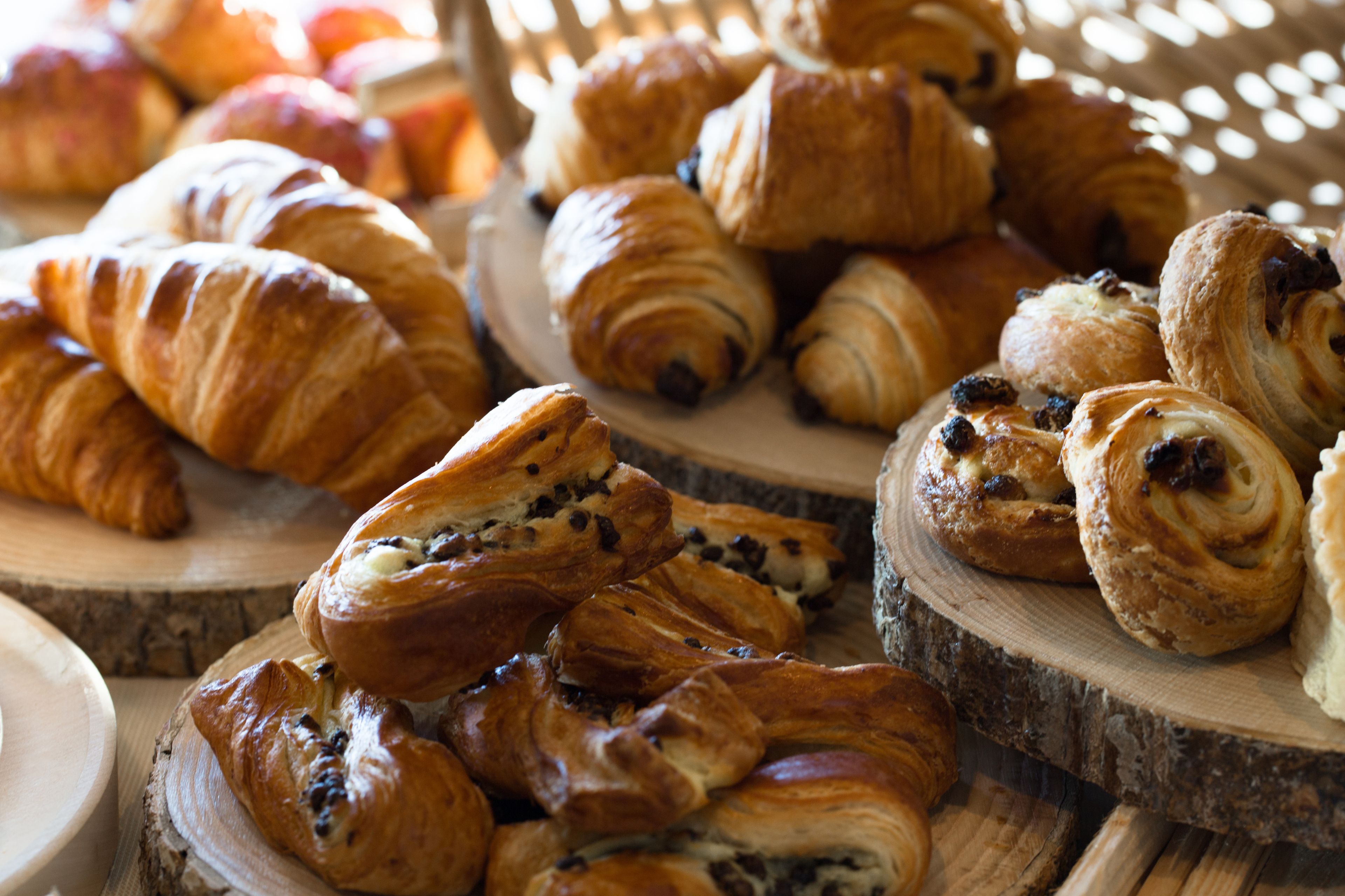 A variety of pastries displayed on wooden boards.
