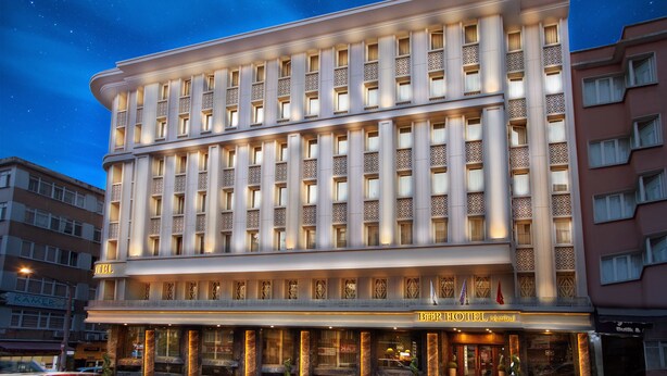A multi-story hotel with a classic architectural design, featuring a prominent entrance with a marquee and a balcony. - Berr Hotel (Istanbul)