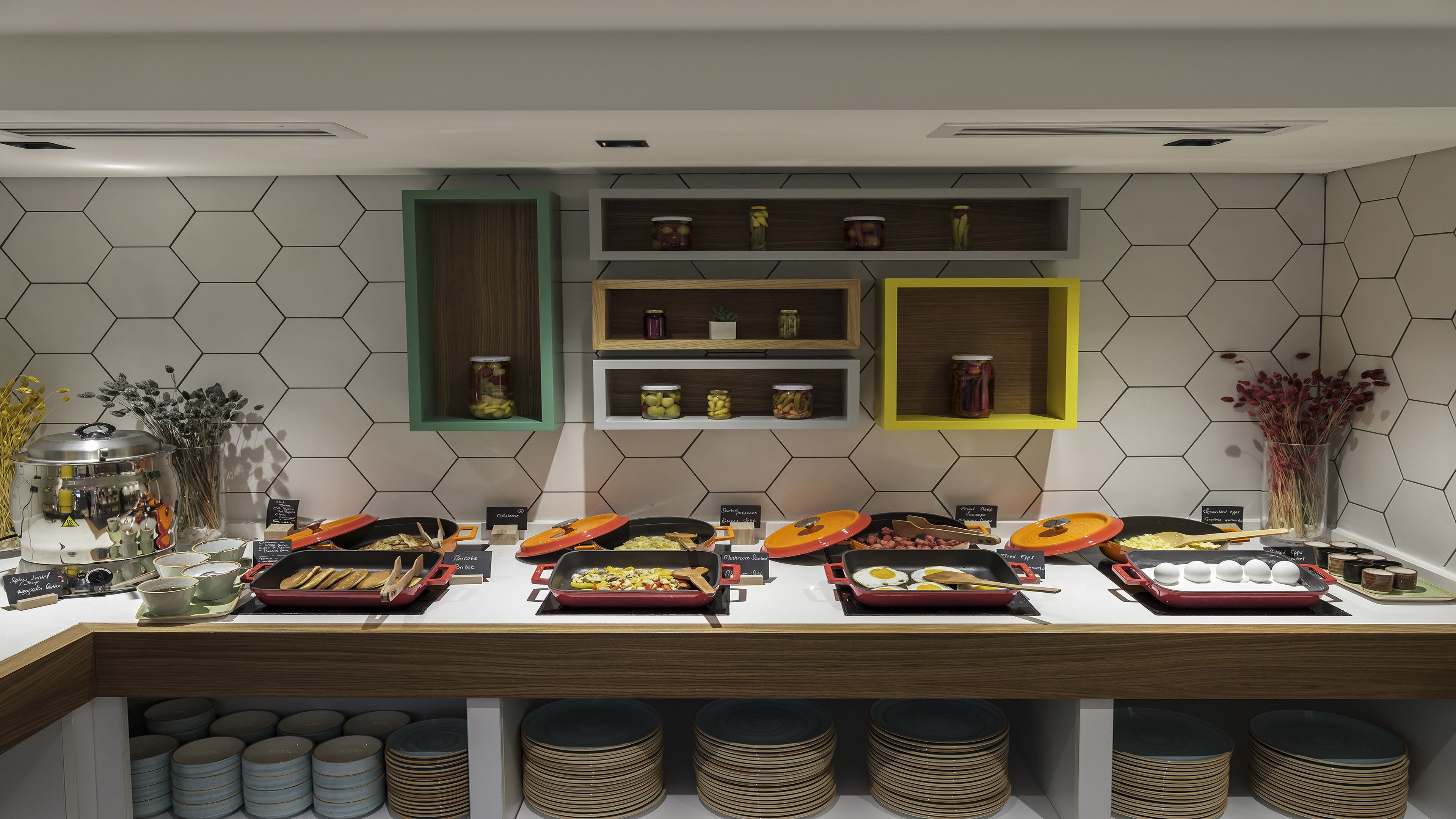A buffet setup with various food items and condiments.