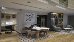 A modern office space with a desk, chairs, a laptop, and a computer monitor. There is a bookshelf with decorative items and a framed picture. - Holiday Inn Istanbul - Old City by IHG (Istanbul)