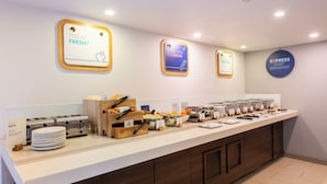 A breakfast buffet with various food items and utensils. - Holiday Inn Express Stirling by IHG (Stirling)
