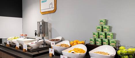 A buffet with various food items and a sign asking if guests feel fresh.