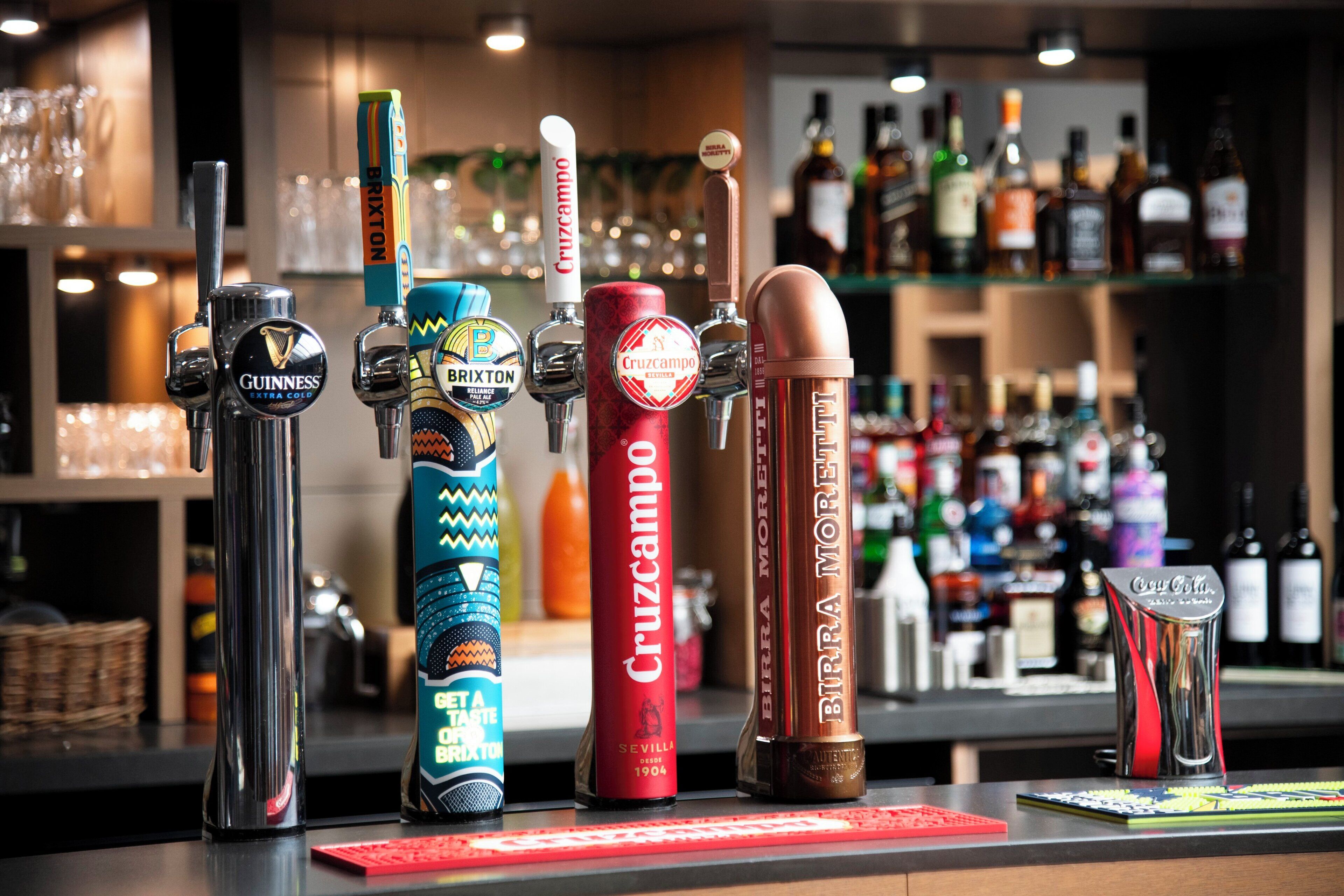 A bar with various beer taps and bottles in the background.