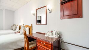 A hotel room with two beds, a wooden desk with drawers, a mirror, and a cabinet. - Comfort Inn Birmingham (Birmingham)