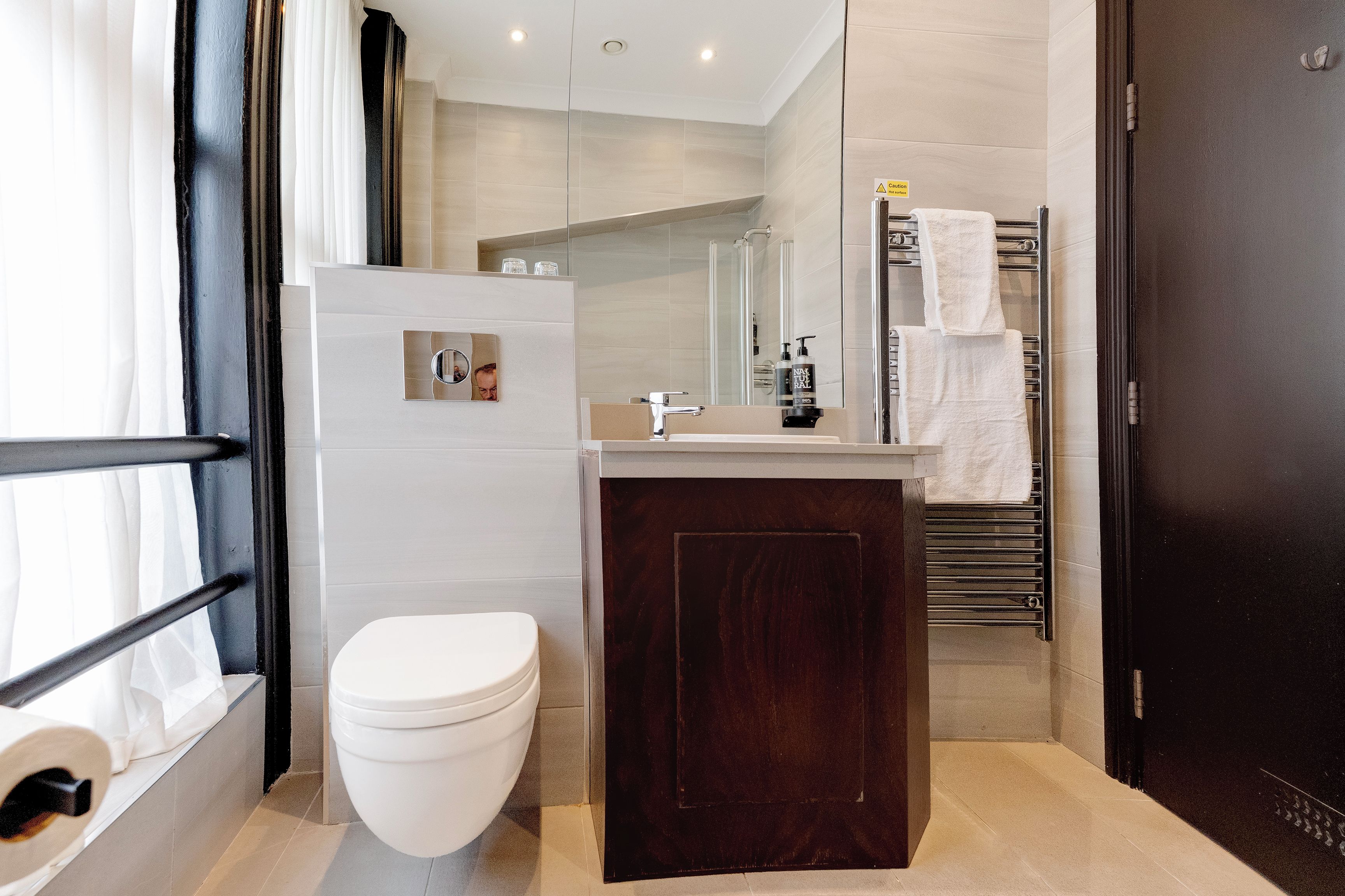 A modern bathroom with a toilet, sink, and shower area.