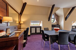 A hotel room with a dining area, a large mirror, a window with curtains, and a view of greenery outside. - The Victoria Hotel, Bradford by Sunday (Bradford)