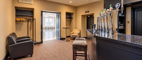 A hotel lobby with a bar area, seating, and a view to the outside.