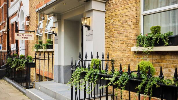 A brick building with a sign reading "The Blandford Hotel". - Blandford Hotel (London)