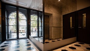 A lobby with a geometric patterned floor, large arched windows, and a dark-toned reception area. - Euston Square Hotel (London)