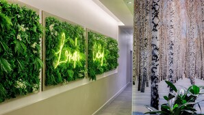 A hallway with vertical gardens and a neon sign that reads 'Love Life.' - DoubleTree by Hilton London Angel Kings Cross (London)