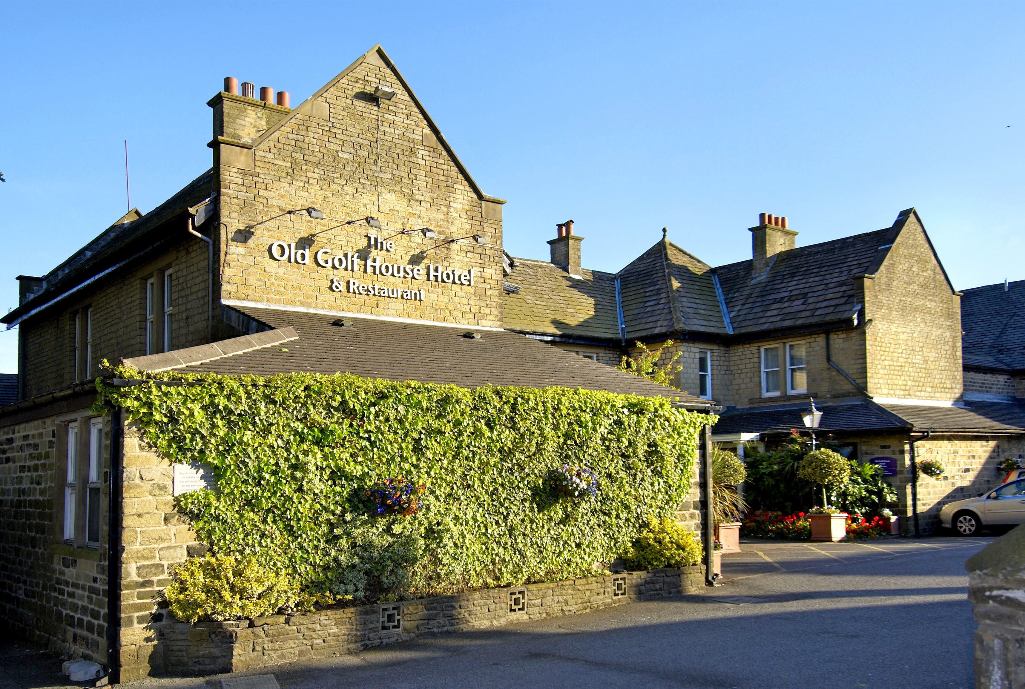 A building with a sign reading "Old Golf House Hotel & Restaurant."