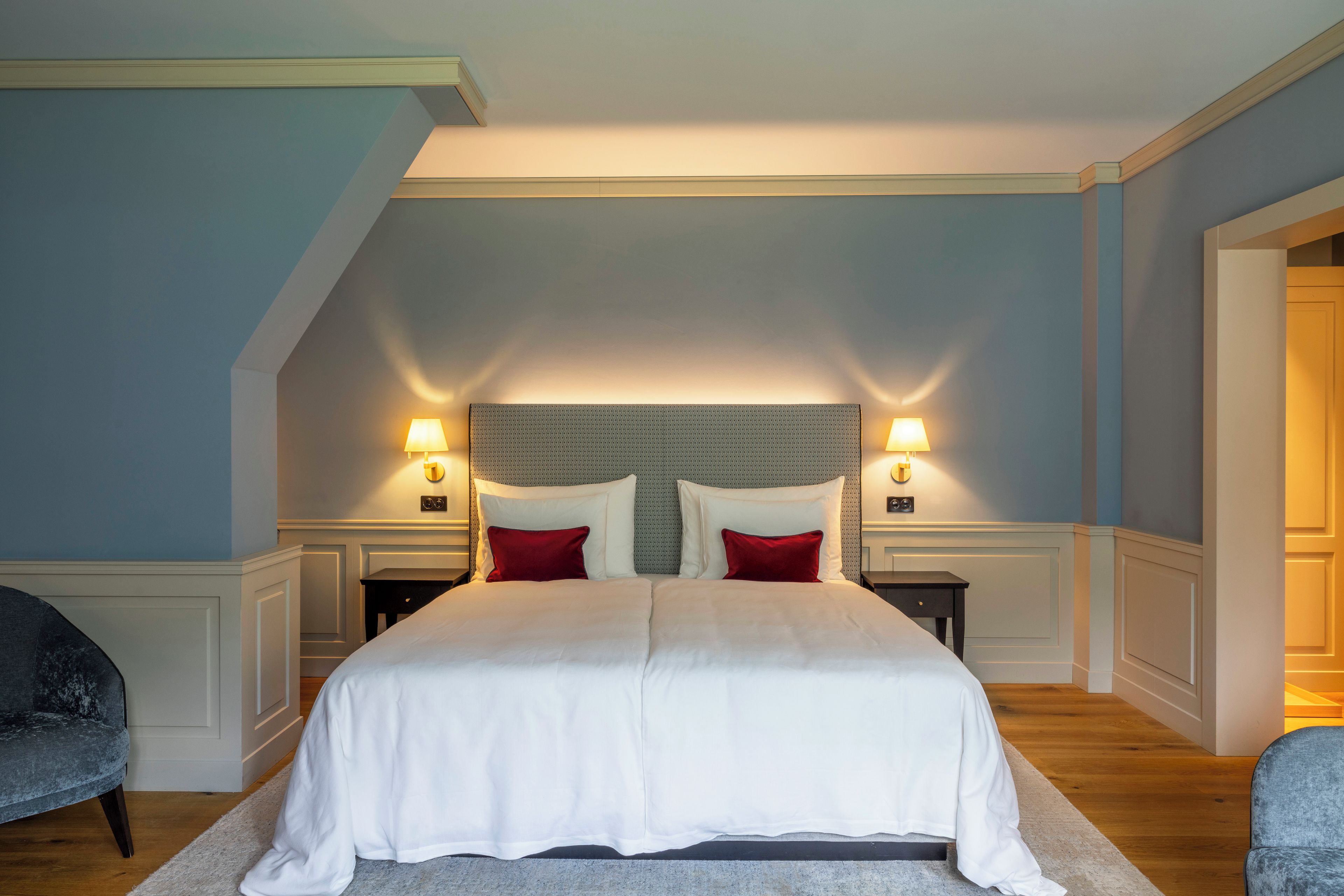 A bedroom with a large bed, two bedside tables, and a nightstand.