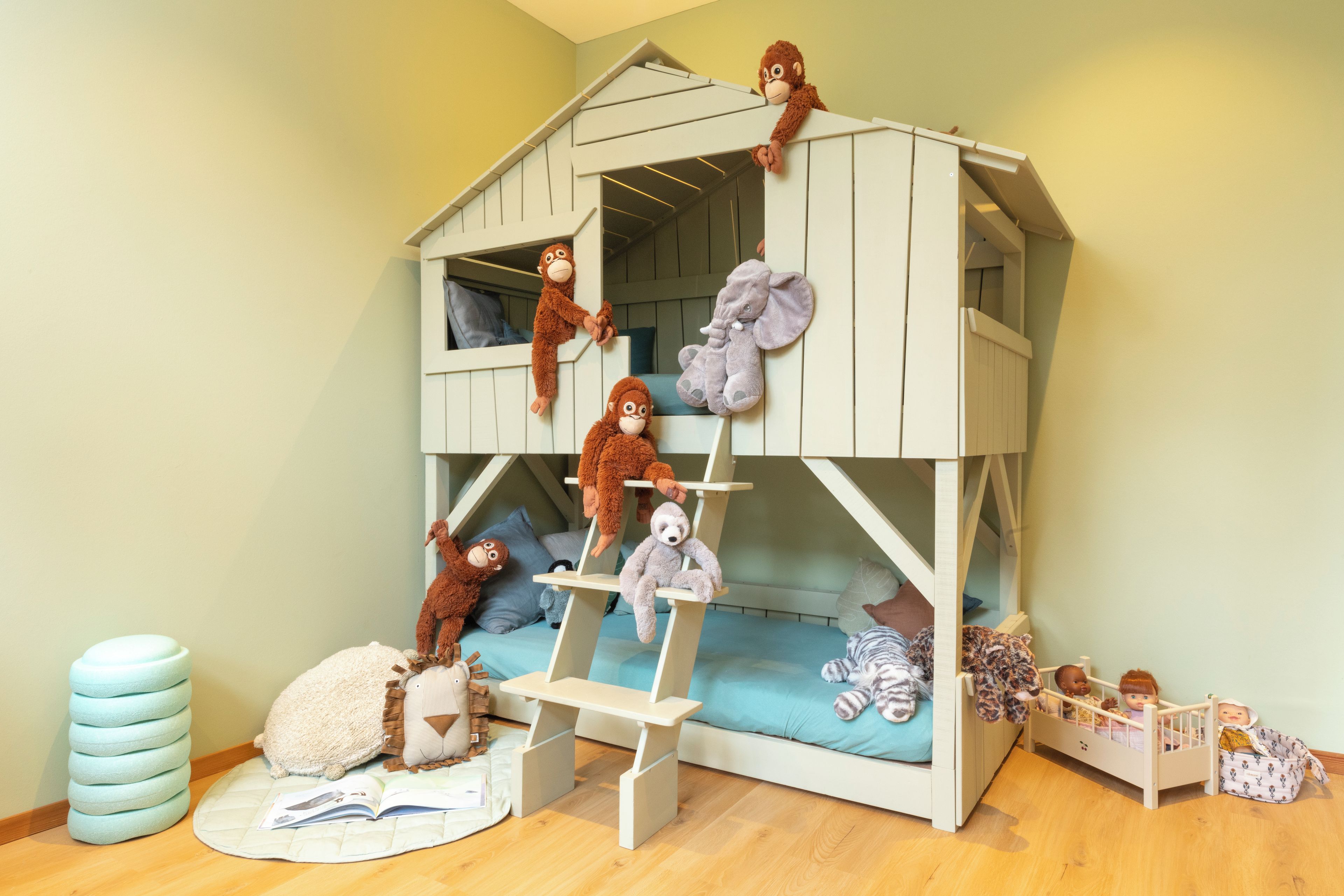 A bunk bed with plush toys on it.