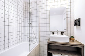 Bathtub, hair dryer, towels, soap