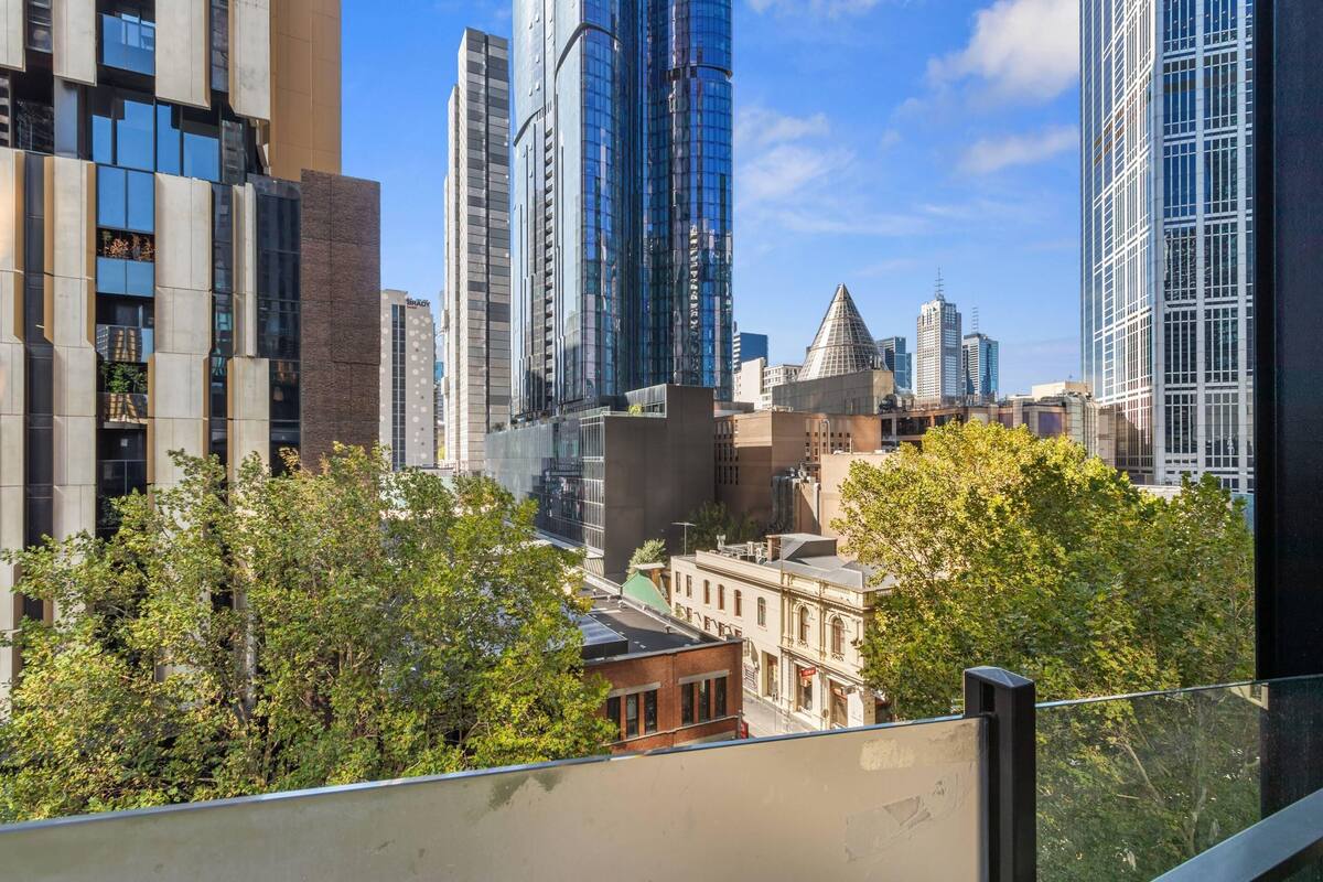 Un paisaje urbano con modernos rascacielos, una mezcla de estilos arquitectónicos y una vista del cielo.