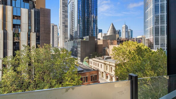 A cityscape with modern high-rise buildings, a mix of architectural styles, and a view of the skyline. - Comfort Apartments on Elizabeth (Melbourne)