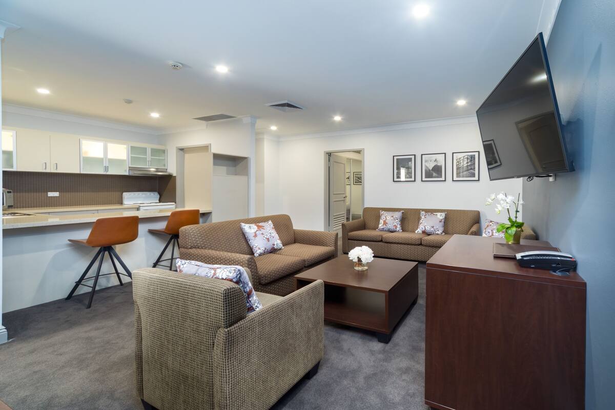 Back 2 Bedroom Apartment 401 (No View) + Light Breakfast placed in Room | Living area | 40-inch LCD TV with cable channels, TV, DVD player