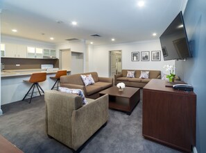 Back 2 Bedroom Apartment 401 (No View) + Light Breakfast placed in Room | Living area | 40-inch LCD TV with cable channels, TV, DVD player