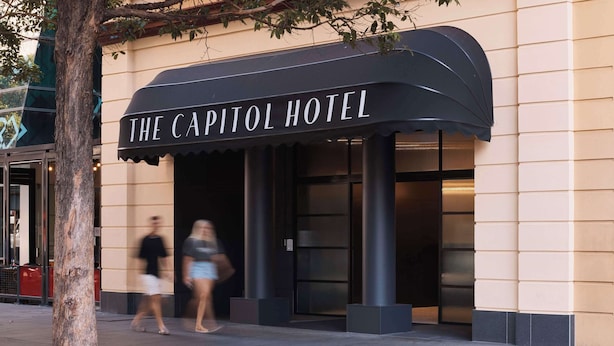The exterior of The Capitol Hotel with a black awning and a modern entrance. - The Capitol Hotel Sydney (Haymarket)
