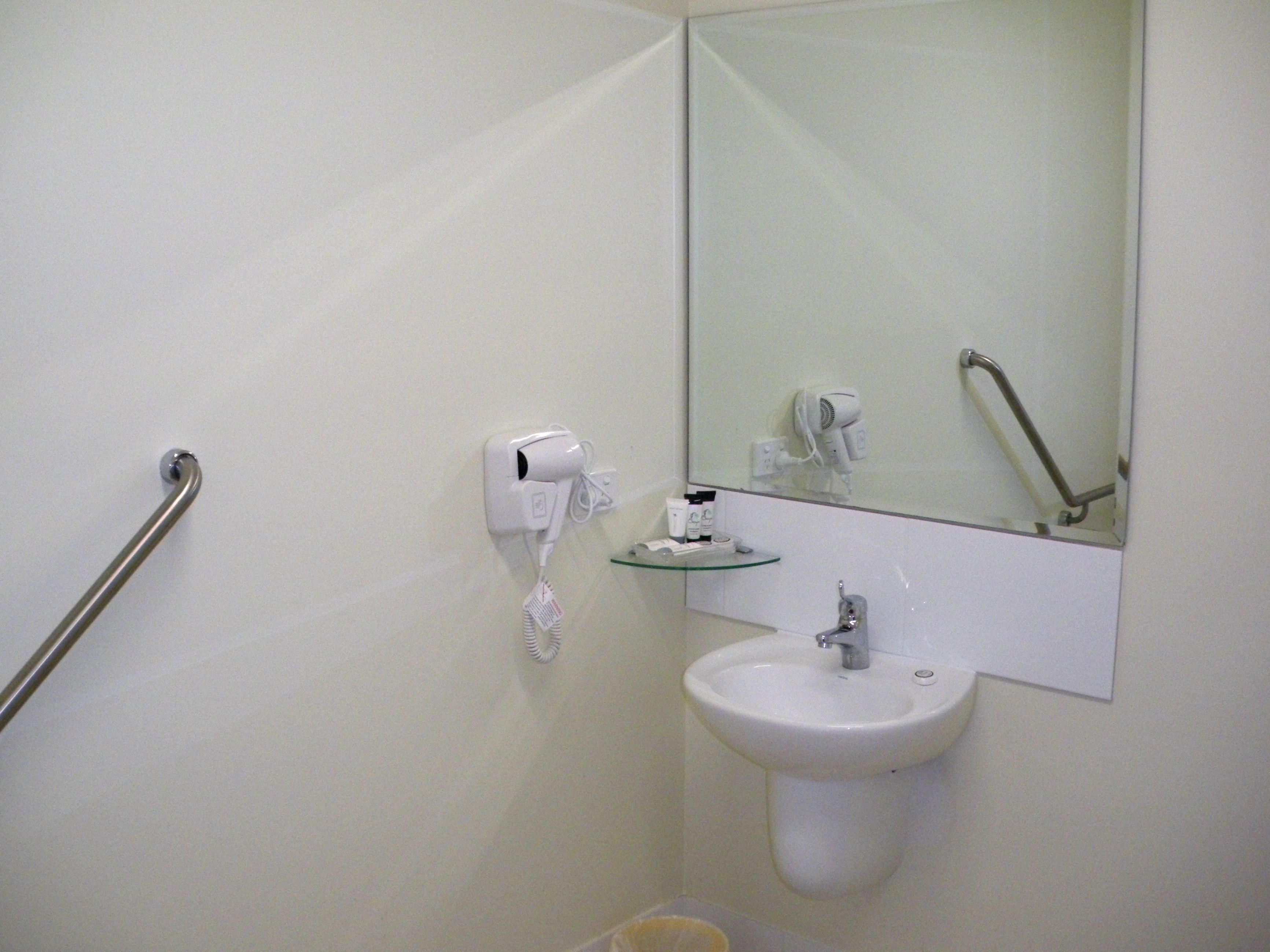 deluxe room, accessible | bathroom | shower, rainfall showerhead, hair dryer, towels