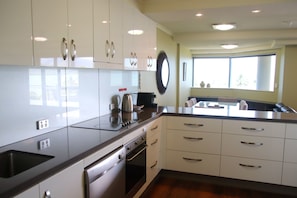 Full-sized fridge, microwave, stovetop, dishwasher