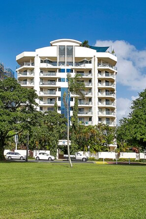 Guests can enjoy balconies with outdoor space on every floor, surrounded by a lush lawn and trees.