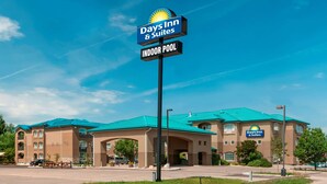 A Days Inn & Suites building with a sign indicating an indoor pool. - Days Inn & Suites by Wyndham Brandon (Brandon)
