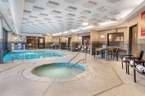 An indoor swimming pool with a hot tub, seating areas, and a ceiling with recessed lighting. - Drury Inn & Suites Atlanta Airport (Atlanta)