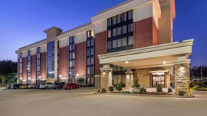 A multi-story hotel with a brick facade, large windows, and a covered entrance area. - Drury Inn & Suites Atlanta Airport (Atlanta)