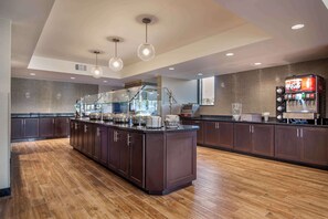 Enjoy cooking in this well-equipped kitchen with a central island, ample counter space, and coffee station.