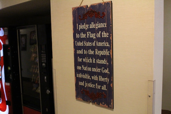 A wall with a sign containing the Pledge of Allegiance.