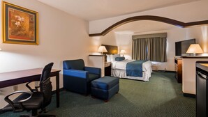 A hotel room with a bed, a desk, a chair, a TV, and a painting on the wall. - Best Western Gas City (Gas City)