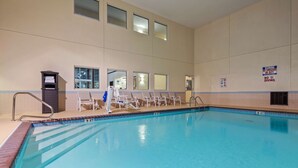 An indoor swimming pool with clear water, a lifeguard stand, and a pool ladder. - Best Western Gas City (Gas City)