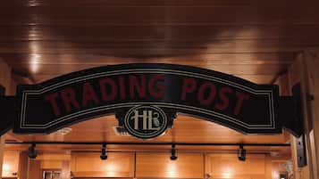 A wooden interior with a sign reading "TRADING POST" and a logo with "HL".