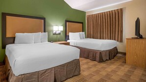 A hotel room with two beds, a TV, a desk, and a lamp. - Extended Stay America Suites Indianapolis West 86th St (Indianapolis)