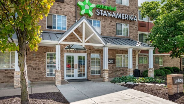 A brick building with a green logo and the words "extended STAY AMERICA" on the facade. - Extended Stay America Suites Indianapolis West 86th St (Indianapolis)