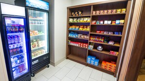 A vending machine and a snack shelf in a room. - Holiday Inn Express Hotel & Suites Goshen by IHG (Goshen)