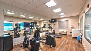 A gym with cardio equipment, mirrors, and a large window. - Holiday Inn Express Hotel & Suites Goshen by IHG (Goshen)
